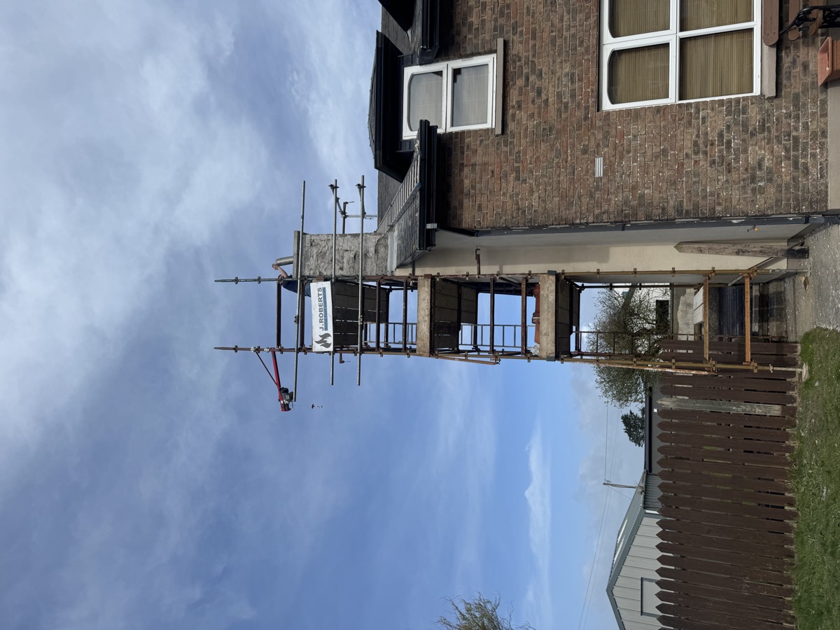 Scaffolding with hoist for chimney rebuild