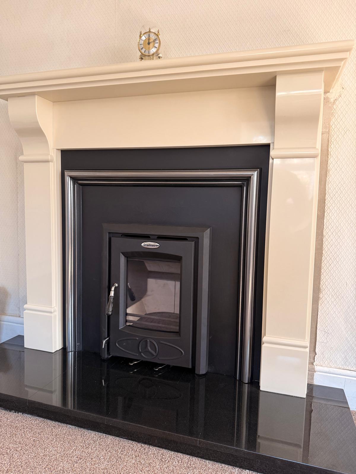 Stove installation finished under a clock mantel