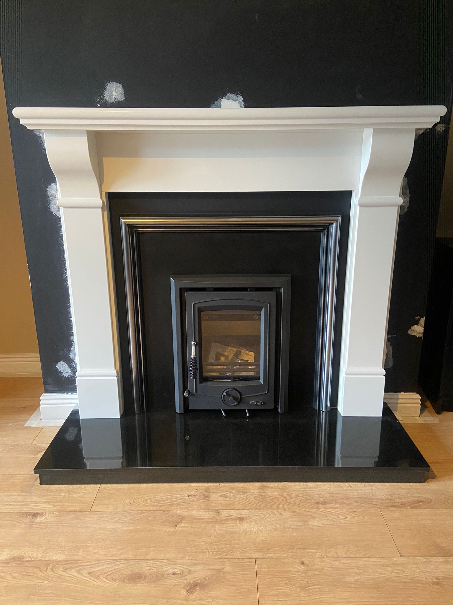 Stove installation against dark feature wall