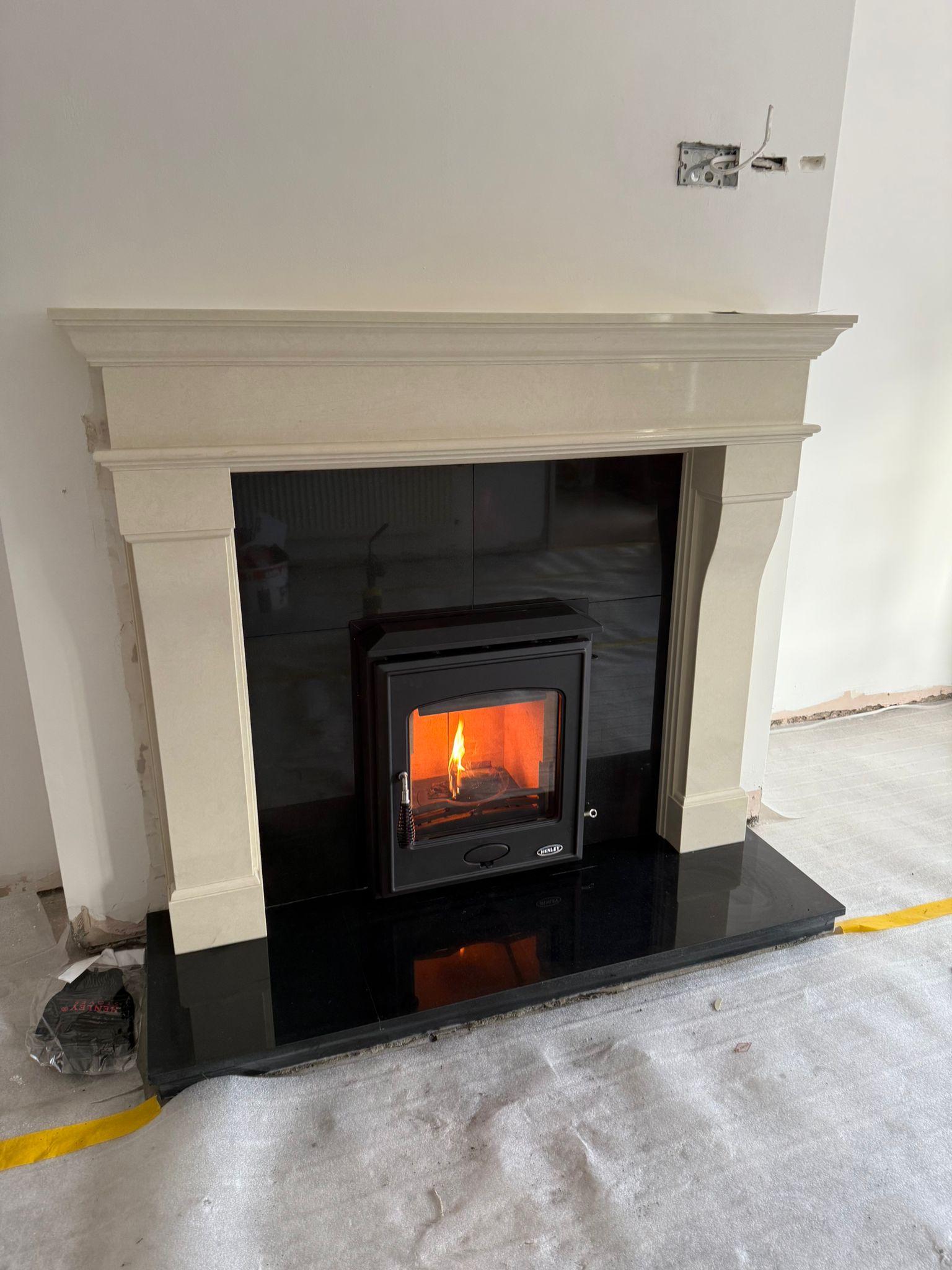 Stove installation in new build with fire lit