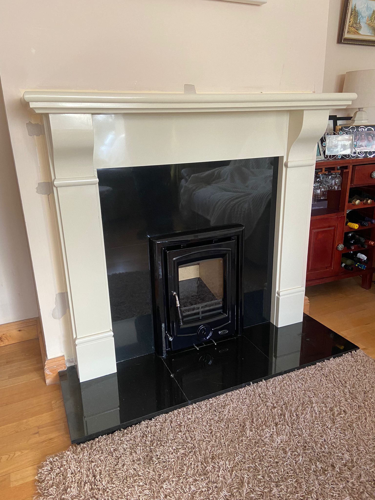Slim inset stove with white surround