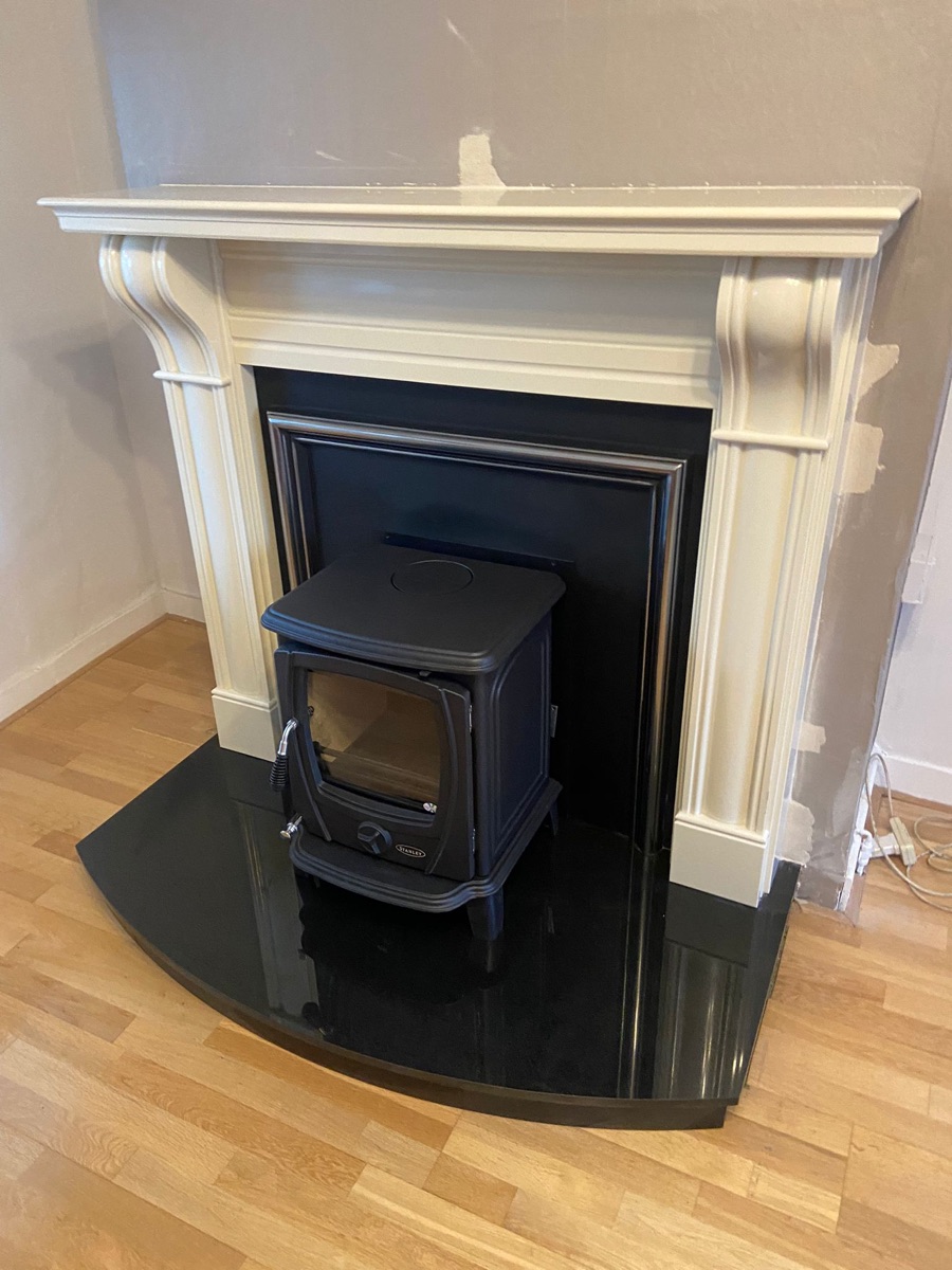 Freestanding stove installed in a Georgian fireplace opening