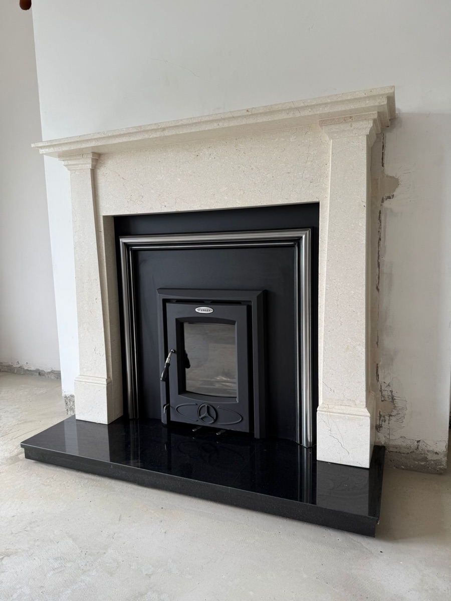 Inset wood burning stove fitted into a marble surround
