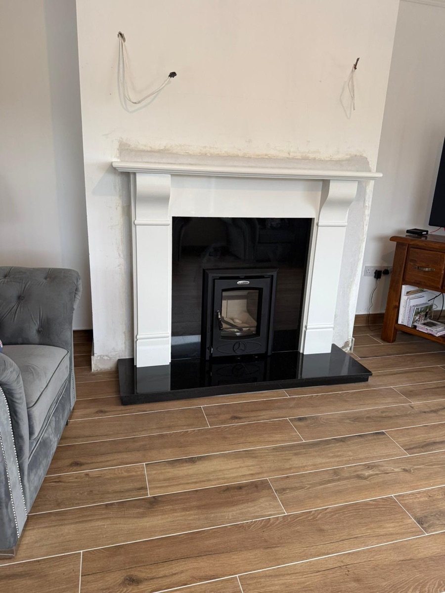 Inset stove fitted flush into a fireplace opening